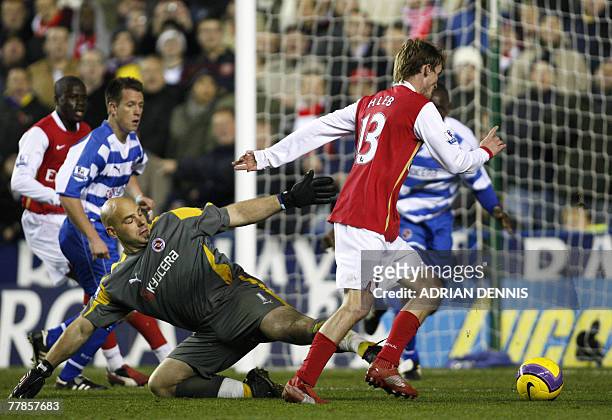 Arsenal's Belarusian player Alexander Hleb prepares to shoot past Reading's goalkeeper Marcus Hahnemann to score their second goal during the...