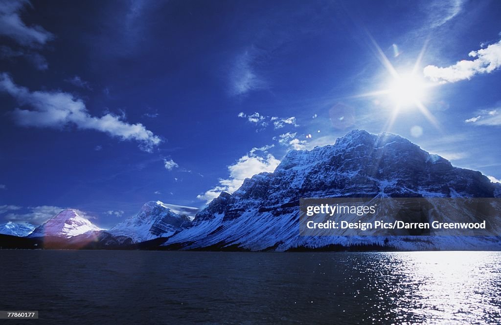 Snow-covered mountains across lake