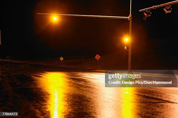 yellow light at intersection at night - yellow light stock pictures, royalty-free photos & images