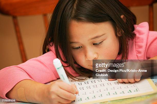 student practices alphabet - workbook stock pictures, royalty-free photos & images