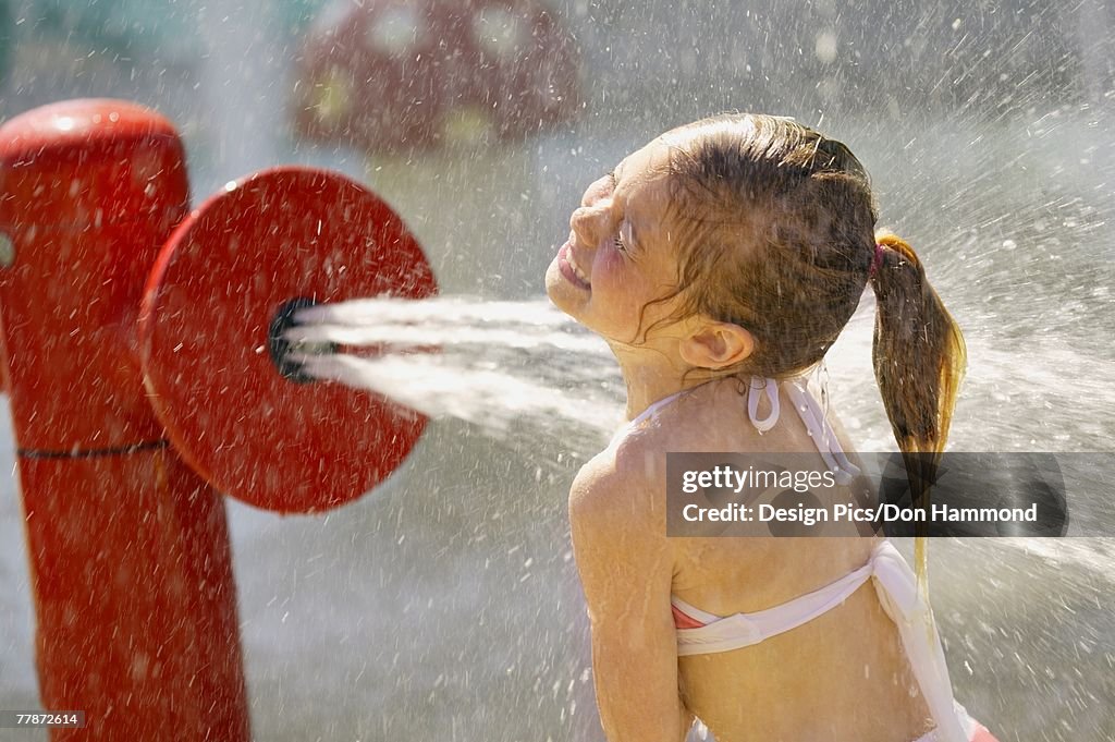 Child getting sprayed with water