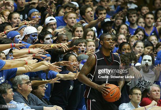 Justin Hawkins of the New Mexico State Aggies throws the ball in as the crowd of the Duke Blue Devils react during their game at Cameron Indoor...