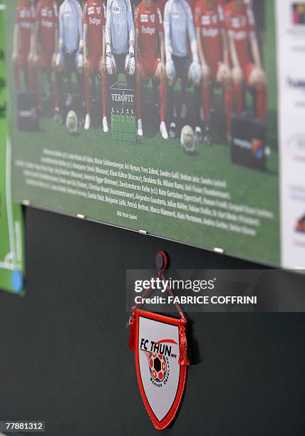 Thun's insigna is seen under a picture of the main team, 13 November 2007 at the Lachen Stadium in Thun. Swiss police arrested 21 men, some of them...