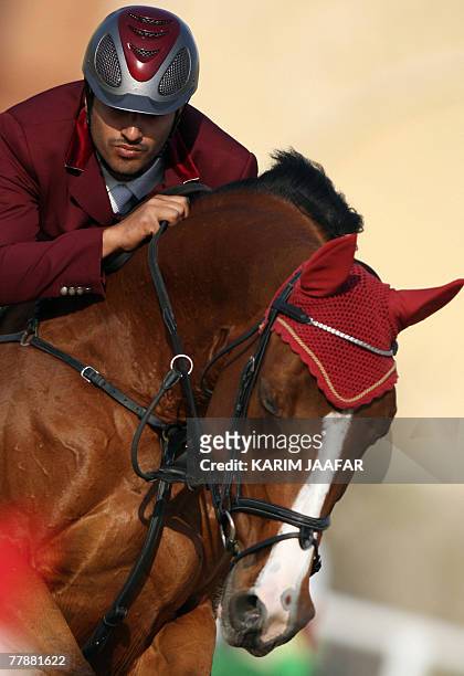 Qatar's Ali al-Rumaihi clears an obstacle with his horse during the 11th Pan-Arab Games in Cairo, 13 November 2007. The Games are a regional...
