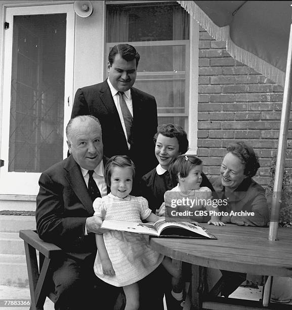 British-born American film and television director Alfred Hitchcock and his wife and frequent collaborator, Alma Reville pose with their daughter,...