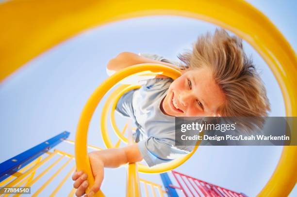 child hangs upside down - climbing frame stock pictures, royalty-free photos & images