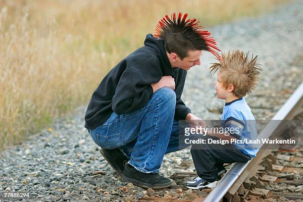two boys with mohawk hairdos - goth boy stock-fotos und bilder