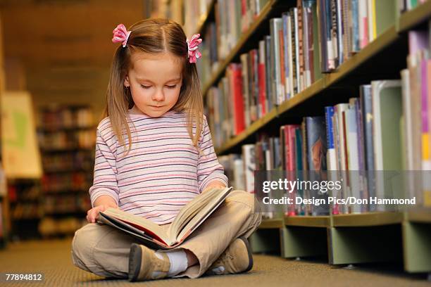 young girl reading a book - edmonton library stock pictures, royalty-free photos & images