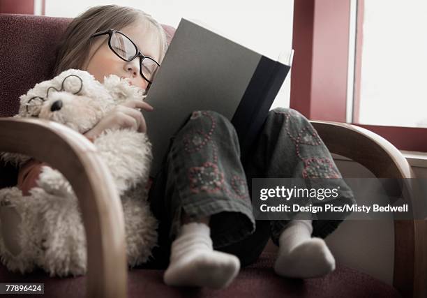 child falls asleep reading a book - edmonton library stock pictures, royalty-free photos & images