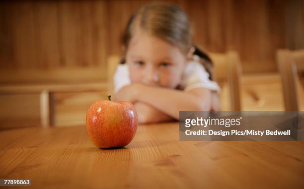 girl staring at an apple - picky eater stock pictures, royalty-free photos & images