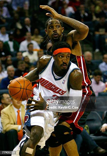 Gerald Wallace of the Charlotte Bobcats drives around Udonis Haslem of the Miami Heat during the second half at Charlotte Bobcats Arena November 13,...