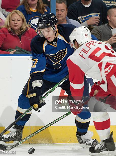 David Perron of the St. Louis Blues battles for the puck with Valtteri Filppula of the Detroit Red Wings at Scottrade Center November 13, 2007 in St....