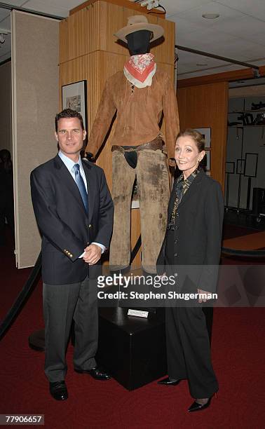 Members of actor John Wayne's family, Christopher Wayne and Gretchen Wayne pose with John Wayne's costume at AMPAS presents the premiere of the...