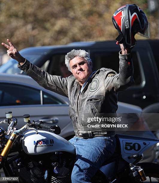 Talk show host Jay Leno gestures from his motorcycle as striking writers walk the picket line, 13 November 2007 outside Universal Studios in...