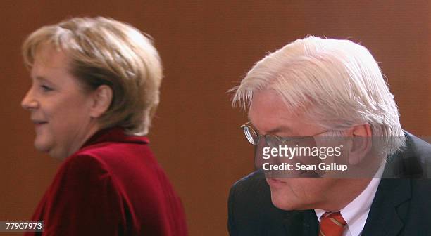 German Chancellor Angela Merkel and Foreign Minister Frank-Walter Steinmeier arrive for the weekly German government cabinet meeting November 14,...