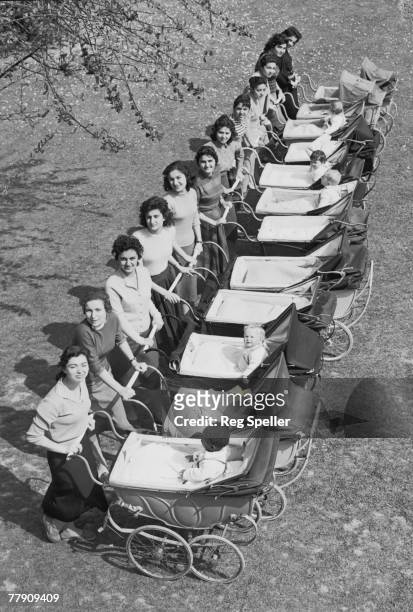 Twelve Persian girls with their charges at the Dr. Barnados Village Home in Barkingside, Essex, 30th April 1957. They are studying Child Care at the...