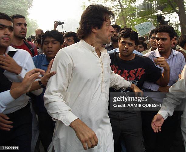 Imran Khan, cricketer turned politician is surrounded by university students in Lahore, 14 November 2007, as he appeared in public for the first time...