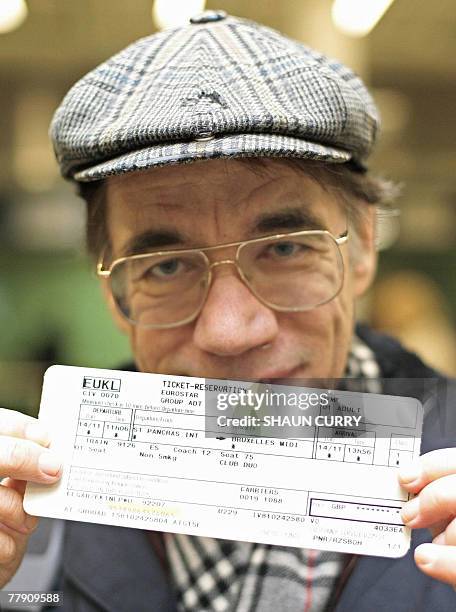 Passenger Roger Kemp displays his ticket for the first Eurostar train leaving St Pancras Station in London bound for Brussels, 14 November 2007....