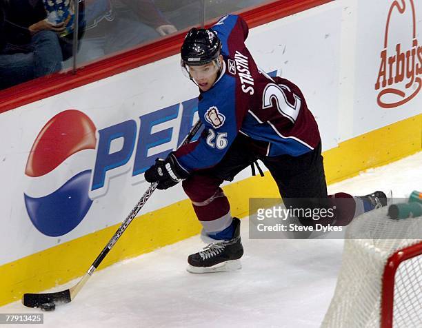 Paul Stastny of the Colorado Avalanche handles the puck behind the net during the hockey game against the Minnesota Wild at the Pepsi Center on...