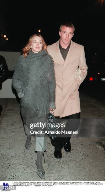 Madonna arrives in a limo along with what seems to be her end-of-millennium man, film maker Guy Ritchie, walking together in and out of the house...