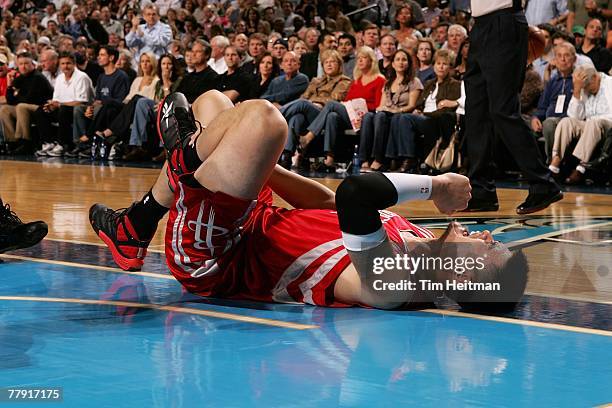 Yao Ming of the Houston Rockets falls on the court after injuring his ankle during the game against the Dallas Mavericks on November 5, 2007 at...