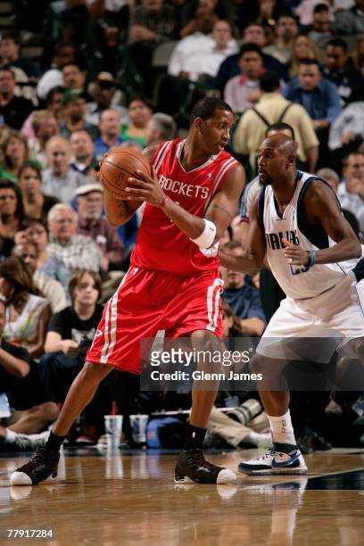 Tracy McGrady of the Houston Rockets goes up against Trenton Hassell of the Dallas Mavericks during the game on November 5, 2007 at American Airlines...