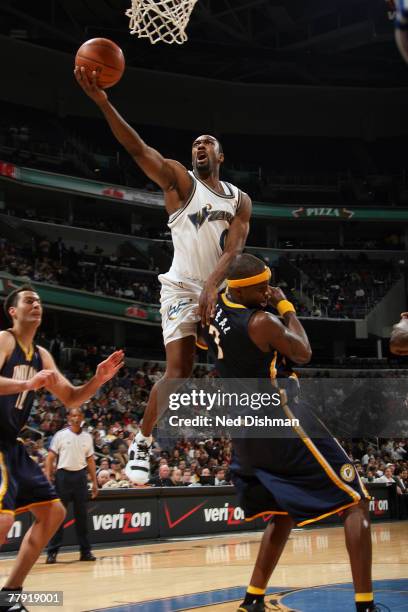 Gilbert Arenas of the Washington Wizards shoots against Jermaine O'Neal of the Indiana Pacers at the Verizon Center on November 14, 2007 in...