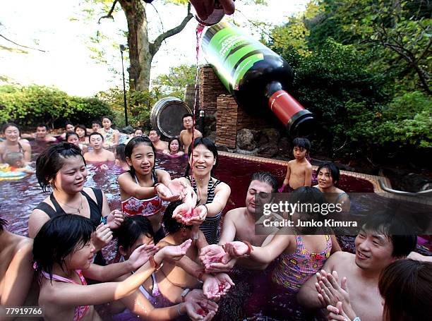 Sommelier pours a bottle of Beaujolais Nouveau to an open air wine spa at the Hakone Kowakien Yunessun on November 15, 2007 in Hakone, Kanagawa...