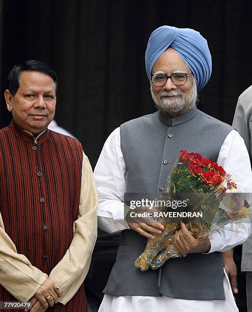 Information and Broadcasting Minister Priya Ranjan Dasmunshi welcomes Indian Prime Minister Manmohan Singh to the opening day of the winter session...