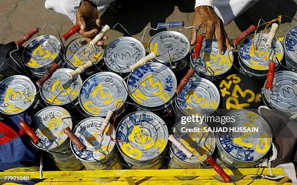 Mumbai dabbawalla, or lunch-box deliveryman, sorts a crate of tiffin boxes in Mumbai, 15 November 2007. Using the Mumbai commuter rail network,...