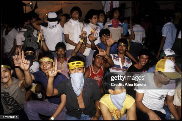 Supporters of opposition leader Cory Aquino outside the Malacanang Palace, Manila, home of President Ferdinand Marcos, 25th February 1986. The mass...