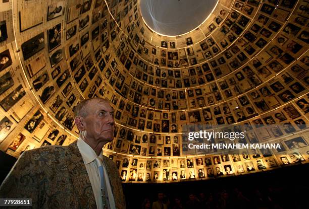 Russian poet, novelist and literature professor, Yevgeny Yevtushenko, looks at photographs of Jews who perished at the hands of the Nazis during the...