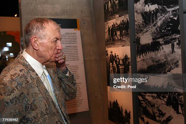 Yevgeny Yevtushenko a Russian poet, novelist and literature professor stands next to his poem 'Babi Yar' written on a holocaust photo during his...