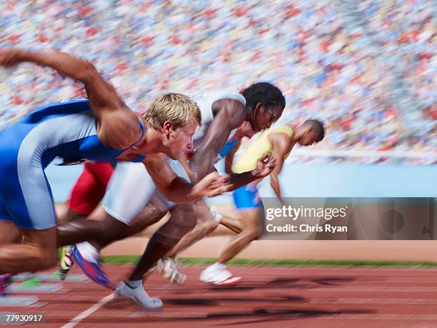 racers at start line on track - athletics arena stock pictures, royalty-free photos & images