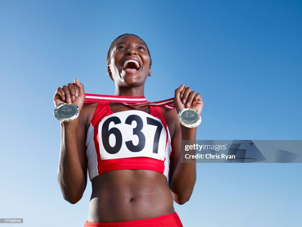 Winning athlete with two medals around neck