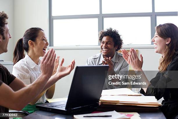 four businesspeople in office applauding - business clapping hands stock pictures, royalty-free photos & images