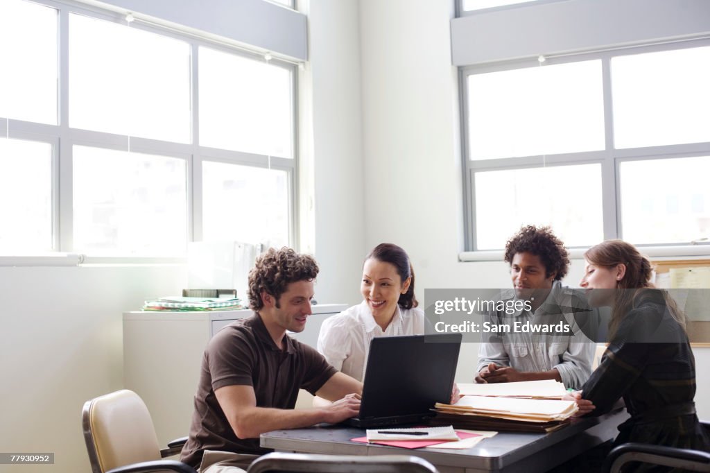 Four businesspeople in an office working