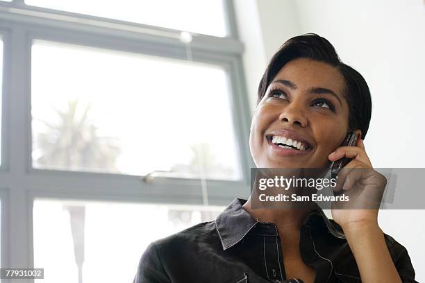 businesswoman on her mobile phont in office - samuser stock pictures, royalty-free photos & images