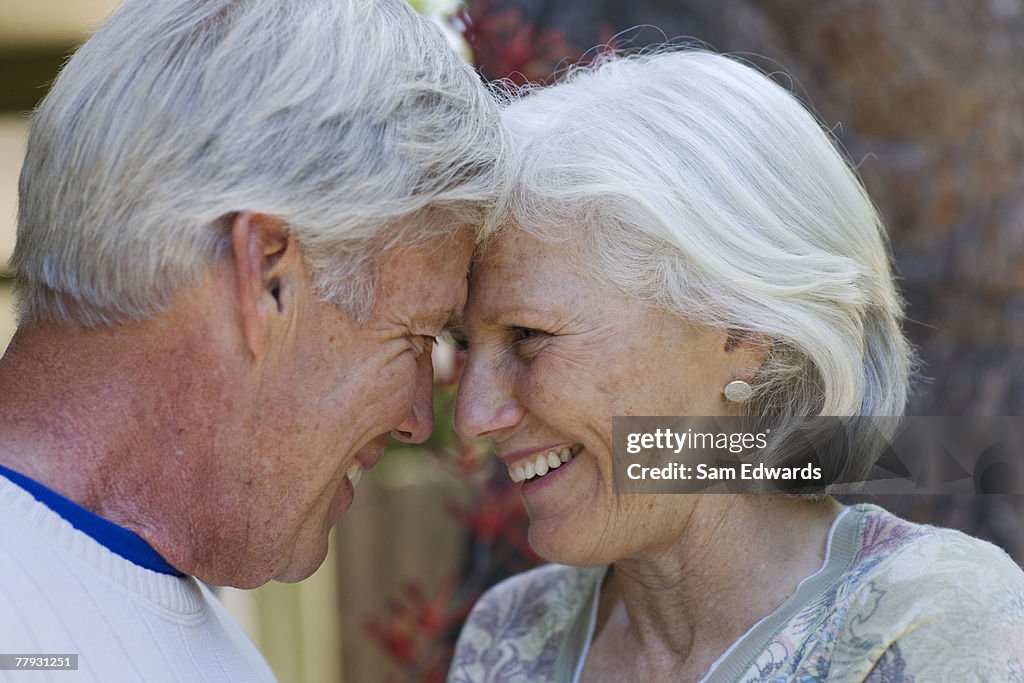 Couple embracing outdoors smiling