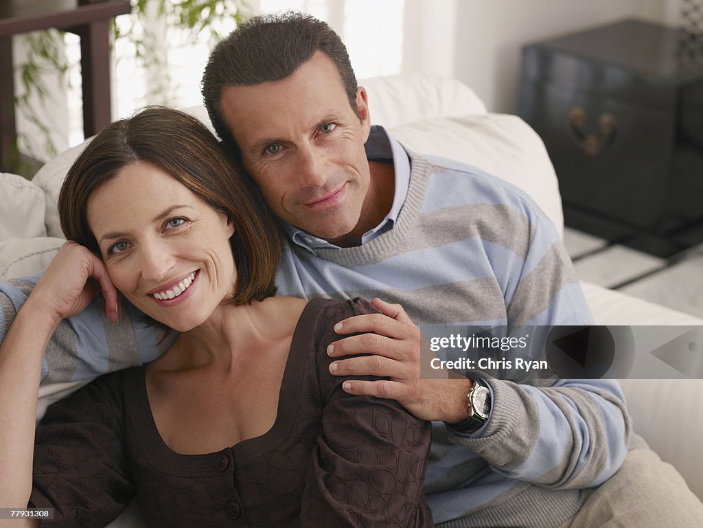 Couple relaxing on sofa in living room