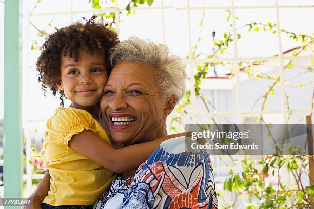 woman and young girl embracing outdoors - family hugging bright stock pictures, royalty-free photos & images