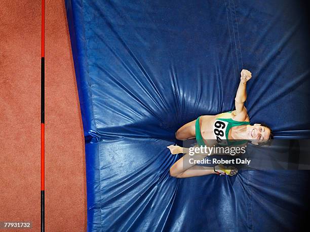 athlete on a crash mat after high jumping - womens high jump stock pictures, royalty-free photos & images