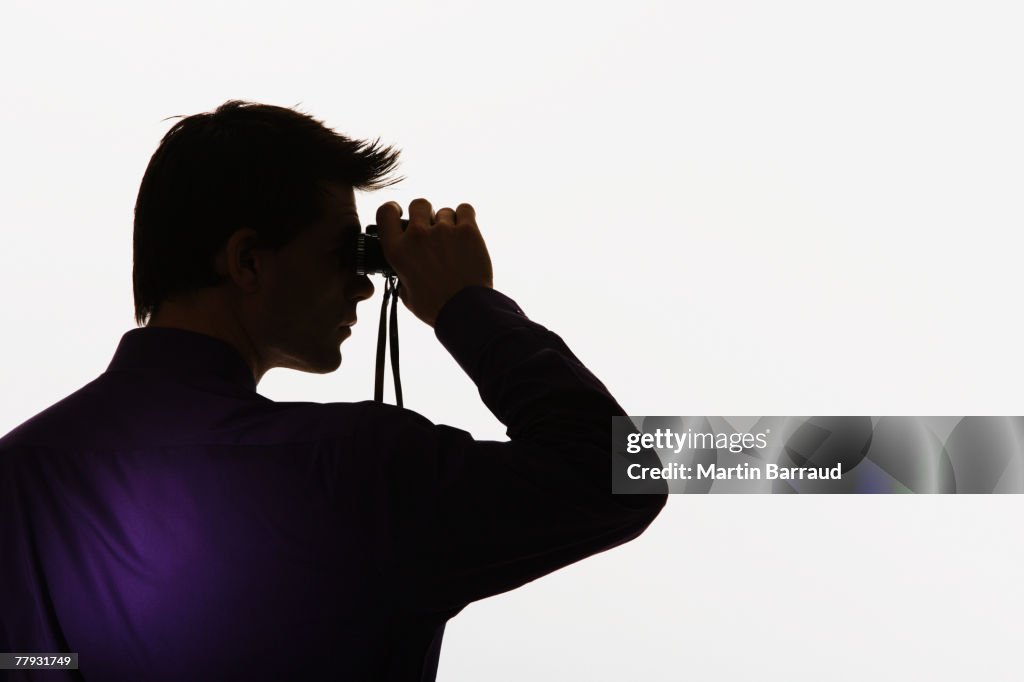 Man looking through binoculars