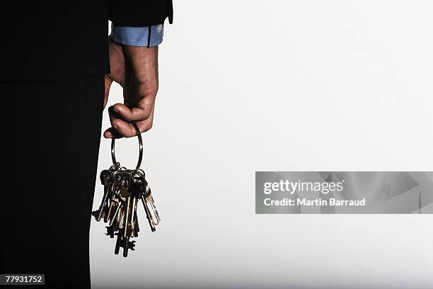 hand holding large ring of keys - key ring stock pictures, royalty-free photos & images