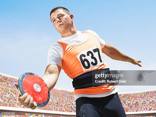 athlete with discus in arena - discus stock pictures, royalty-free photos & images