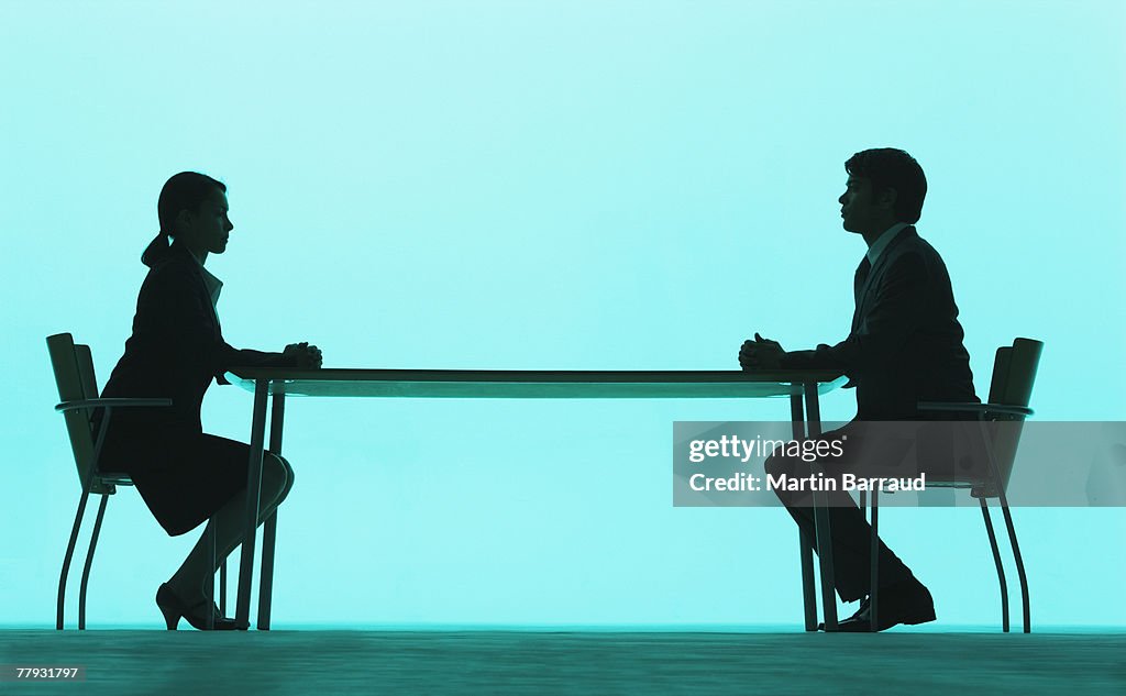 Businessman and businesswoman at a table