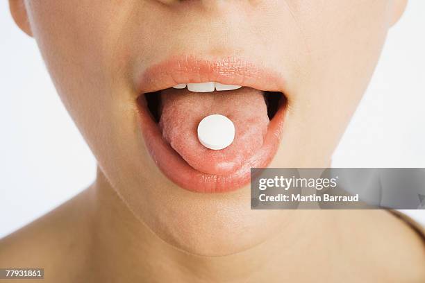 pill on a tongue - from inside mouth stock pictures, royalty-free photos & images