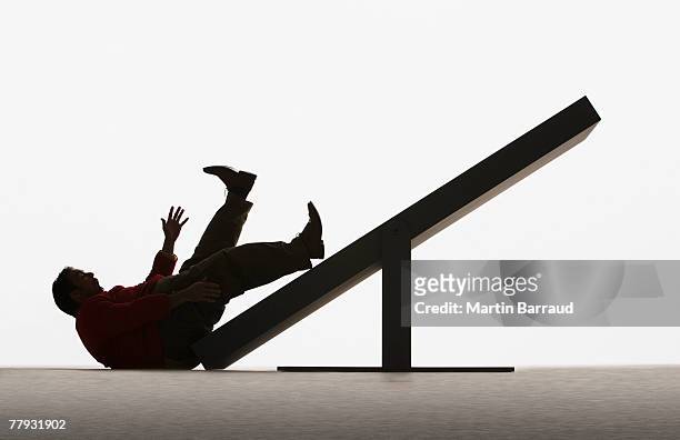 large man falling off end of plank - fat silhouette stockfoto's en -beelden