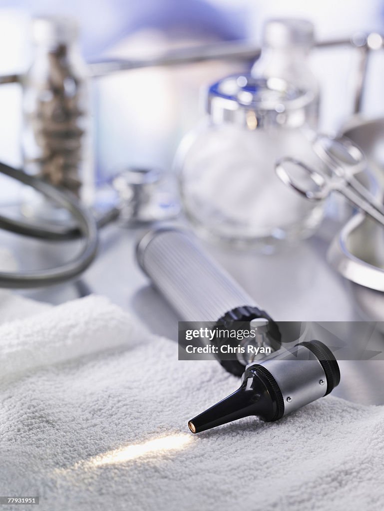 Otoscope and medical supplies on table