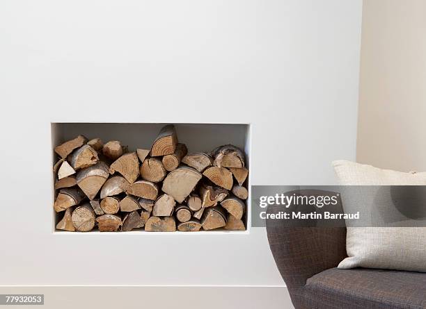 pile of wood beside chair indoors - niche stock pictures, royalty-free photos & images